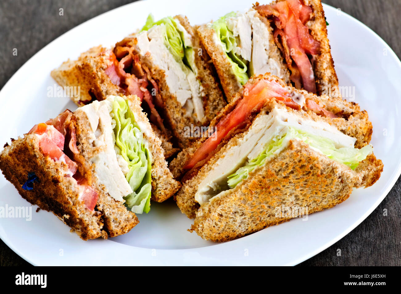 chicken sandwich association club tomato lettuce bacon food aliment bread hot Stock Photo