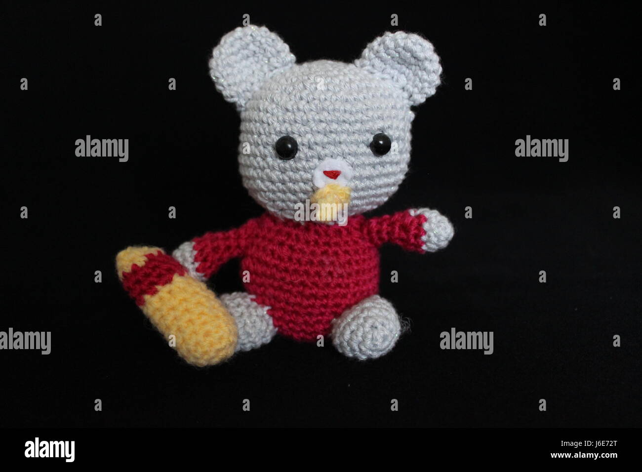 Woolen toy made in crochet and hand on black background Stock Photo