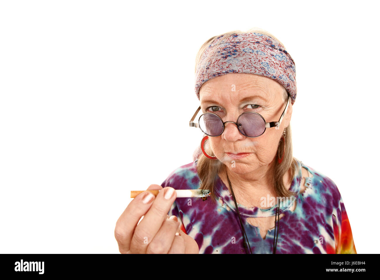 woman cigarette lady female hippie old smoker whiff smoke smoking woman Stock Photo