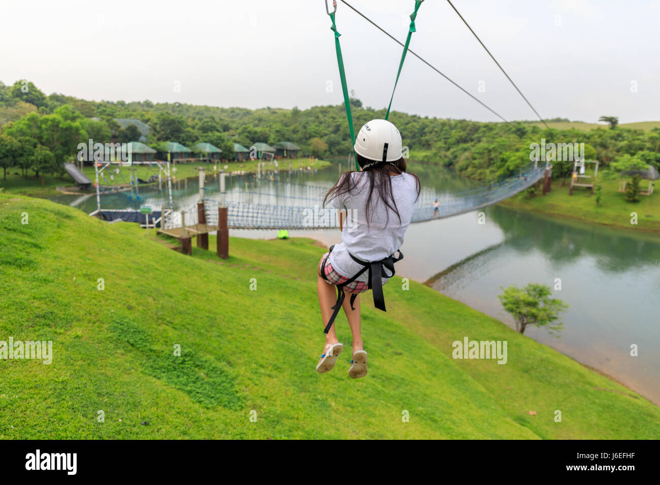 Apr 23, 2017 Woman sliding on a zip line adventure at Mountain lake resort in Laguna, Philippines Stock Photo