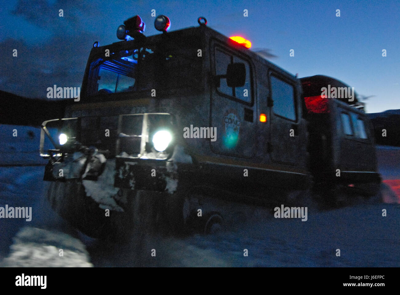 An M973A1 Small Unit Support Vehicle or SUSV, clad in emergency lights and digital camouflage, claws its way through the snow at Taylor Park Reservoir near Gunnison, Colo., March 15, 2010. The SUSV, which is capable of traversing almost any terrain, is the primary vehicle used by the Colorado Army National Guard’s Snow Response Team. This relatively unknown asset can be used by the SRT to assist state and local rescue teams during nearly every type of disaster, state emergency or search and rescue. (U.S. Army National Guard photo by Spc. Joseph K. VonNida, Colorado National Guard) Stock Photo