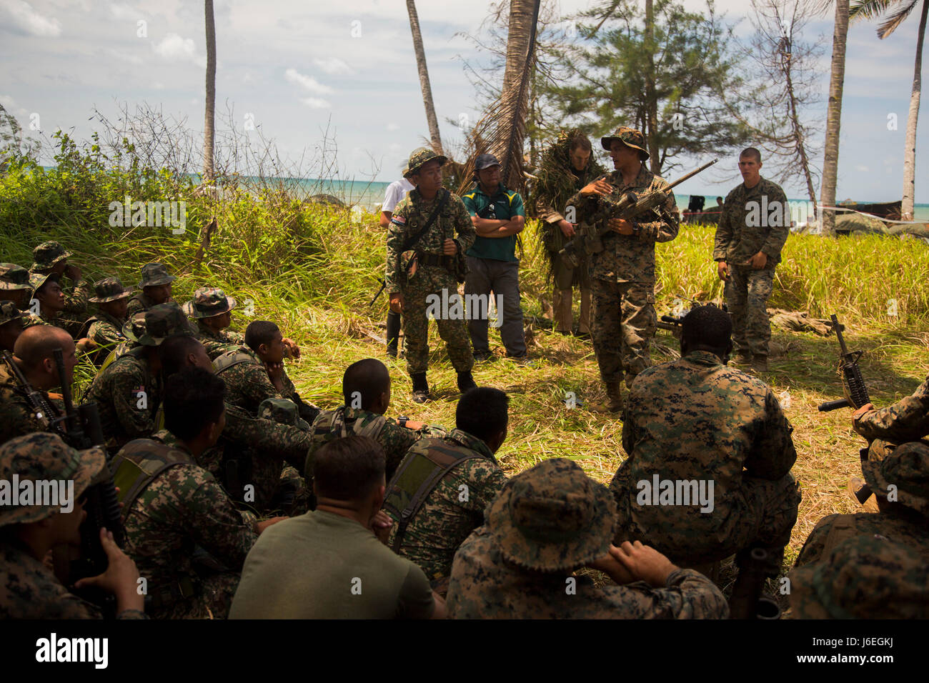 U.S. Marine Corps Cpl. Danny VillaGomez, a rifle man with Golf Company, 2nd Battalion, 4th Marine Regiment, gives a class to Malaysian soldiers about the M110 Semi-Automatic Sniper System during Landing Force Cooperation Afloat Readiness and Training (LF CARAT) 2015 at Tanduo Beach, East Sabah, Malaysia, Aug. 17, 2015. LF CARAT is meant to strengthen, increase the interoperability in amphibious planning and operations and the core skill sets between the United States and the nations of Indonesia, Malaysia, and Thailand. (U.S. Marine Corps photo by MCIPAC Combat Camera Lance Cpl. Sergio Ramirez Stock Photo