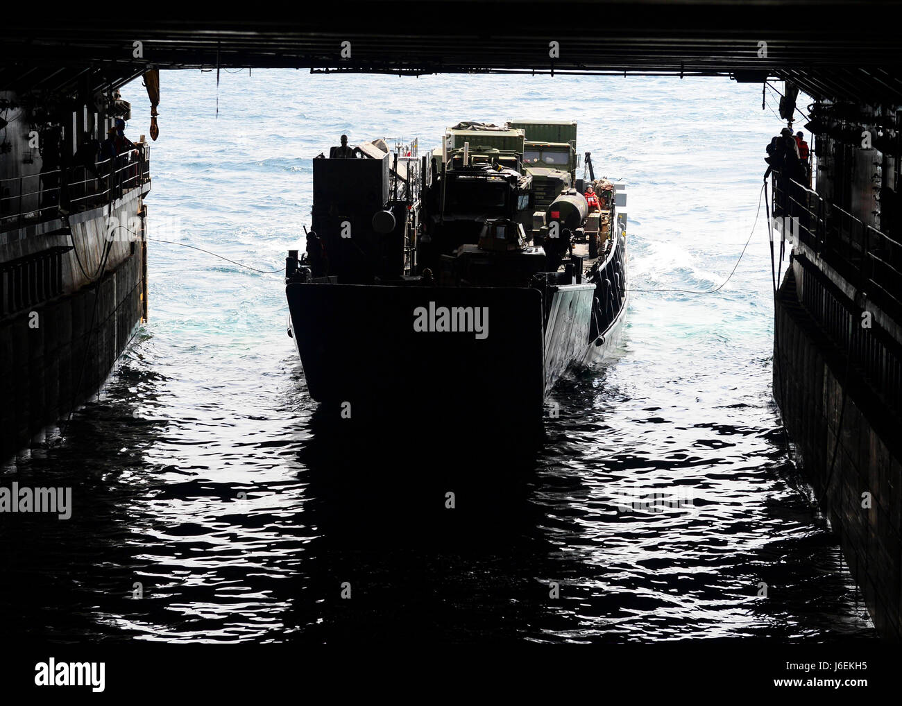A landing craft, utility enters the well deck of amphibious dock ...
