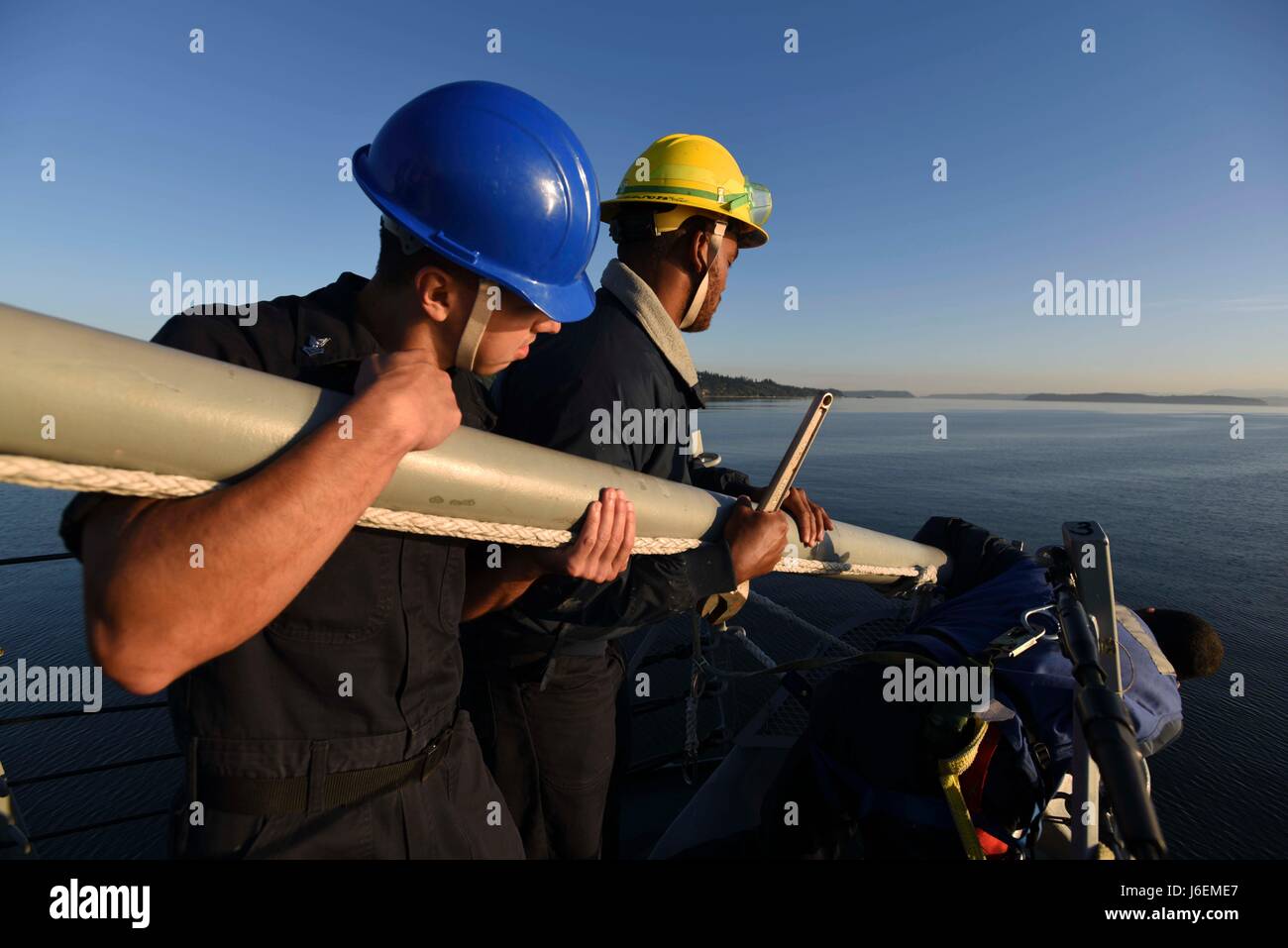 Sailors aboard USS Shoup install the ship's jack-staff while preparing ...
