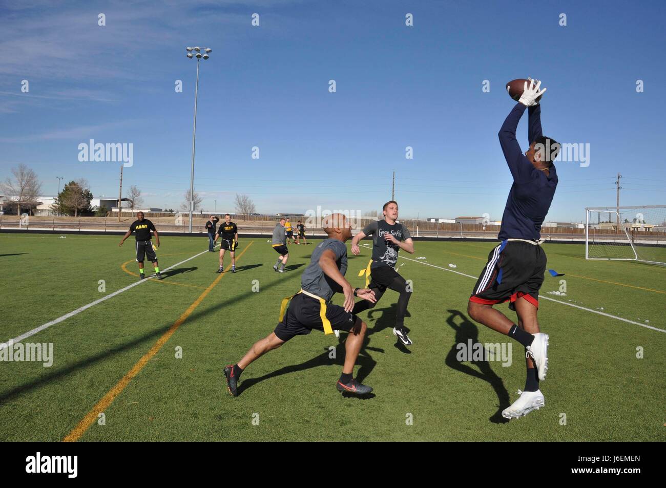 AURORA, Colo. (Dec. 9, 2016) Petty Officer 3rd Class Jay Atkins, assigned to Navy Information Operations Command (NIOC) Colorado/Task Force 1080, catches a 25-yard touchdown pass during an annual Army-Navy flag football game at Buckley Air Force Base in Aurora, Colo. The NIOC Colorado Navy flag football team was defeated by the Army  team by a score of 14-8. (U.S. Navy photo by Petty Officer 2nd Class Robert A. Hartland/Released) Stock Photo