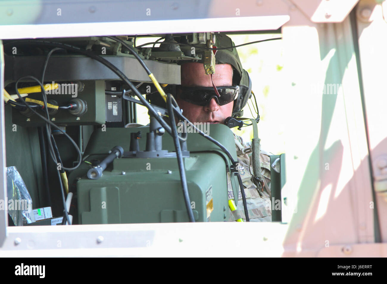 Staff Sgt. Josh Robinson, an air and missile defense crewmember assigned to Battery C, 2nd Battalion, 44th Air Defense Artillery Regiment, 101st Airborne Division (Air Assault) Sustainment Brigade, 101st Abn. Div., reports the status of his crew, April 25, 2017, during a missile upload and download crew drill on Fort Campbell, Kentucky. (U.S. Army photo by Sgt. Neysa Canfield/101st Airborne Division Sustainment Brigade Public Affairs) Stock Photo