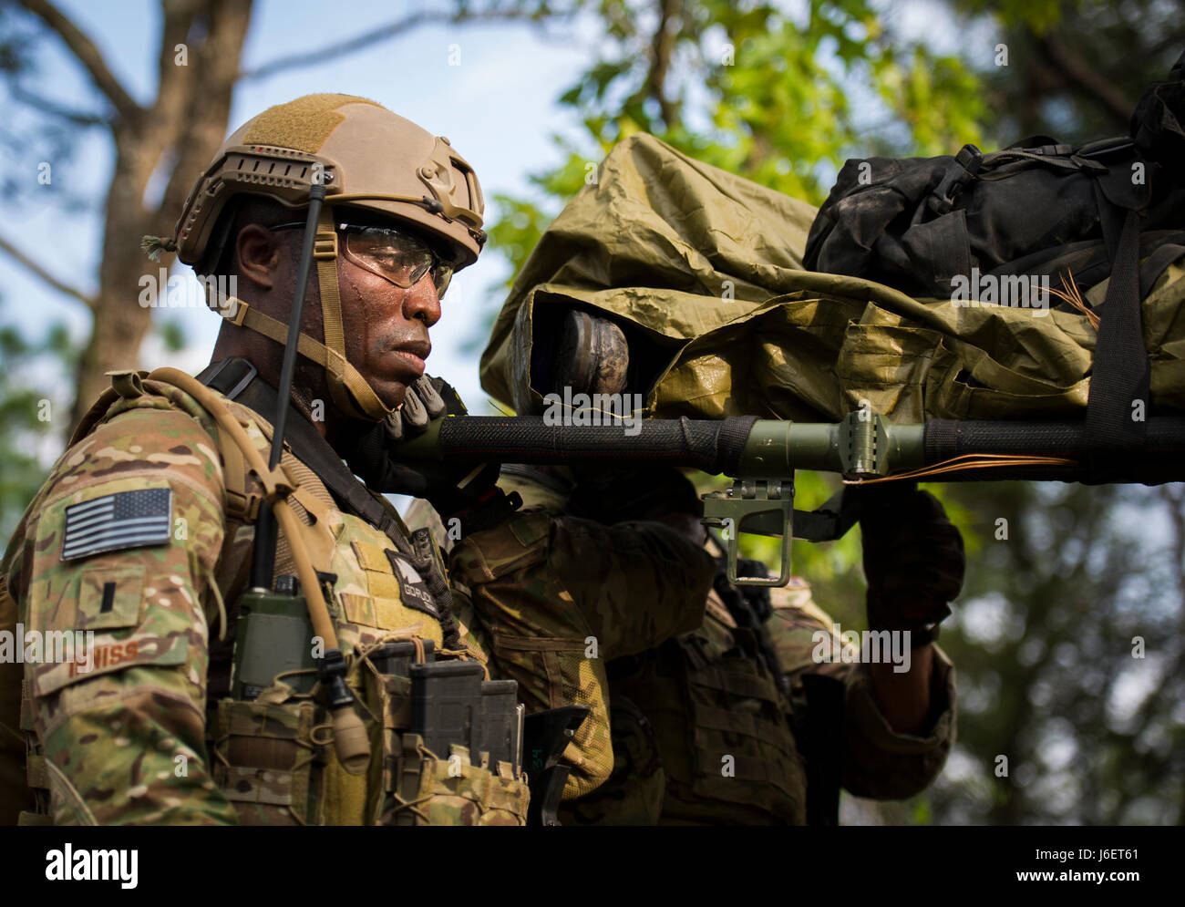 First Lt. Korde Inniss, a combat aviation advisor student with the 6th Special Operations Squadron, carries a litter through the woods during Operation Raven Claw at Duke Field, Fla., April 27, 2017. Students came under simulated fire from hostile forces during a checkpoint and had to navigate through the woods to a safe location while carrying a casualty weighing approximately 210 pounds. (U.S. Air Force photo by Airman 1st Class Joseph Pick) Stock Photo