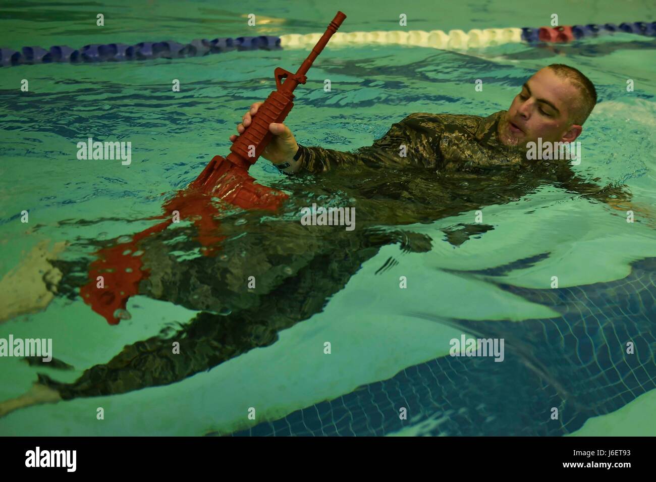 U.S. Air Force Tech. Sgt. George Daggett, 633rd Security Forces Squadron swing shift flight chief, performs a recovery swim during a training evolution at Joint Base Langley-Eustis, Va., April 28, 2017. The 633rd SFS Emergency Services Team conducted a test trial for a course future candidates will have to accomplish in order to join the EST ranks. (U.S. Air Force photo/Senior Airman Derek Seifert) Stock Photo