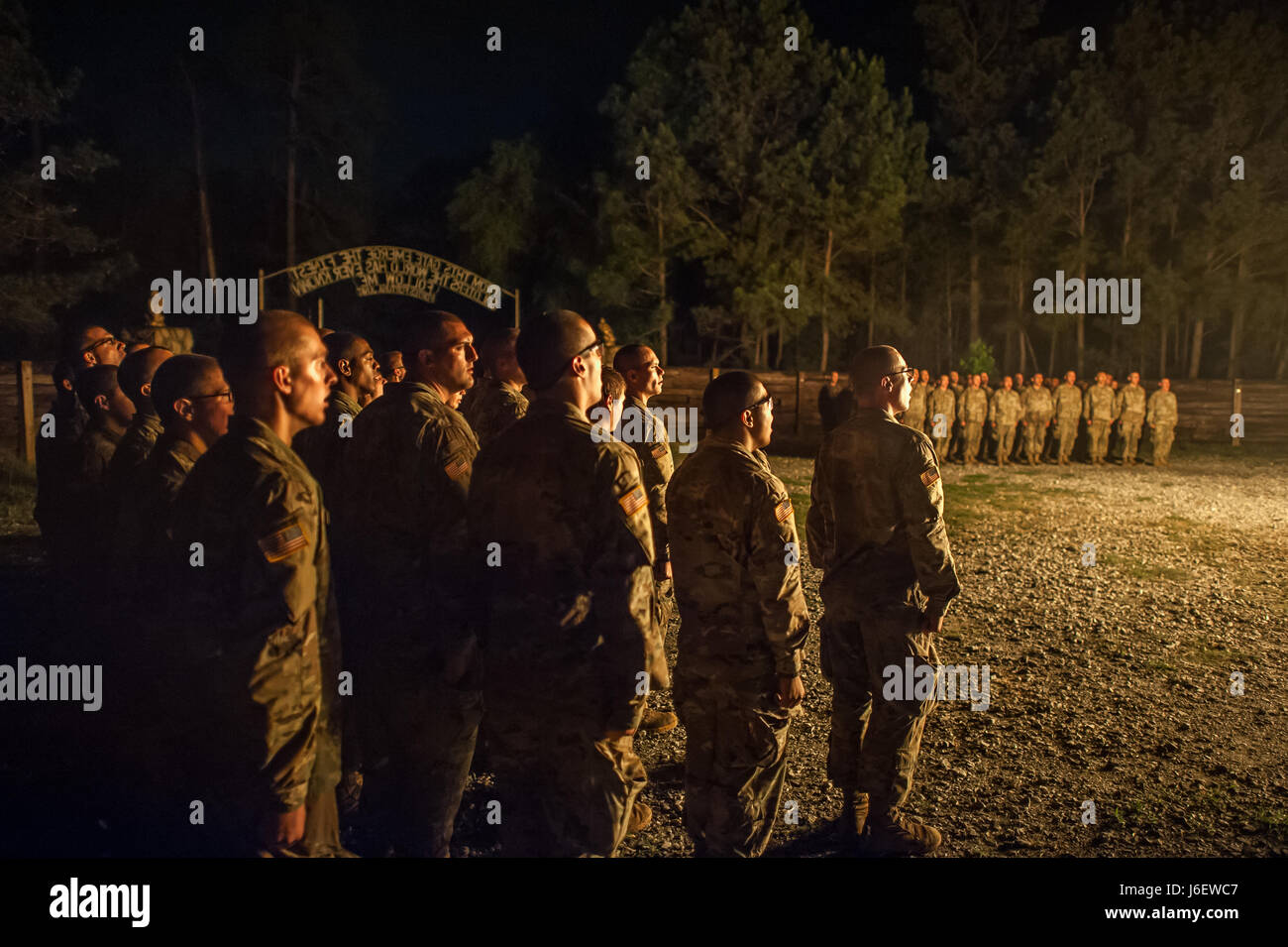 (FORT BENNING, Ga.) – U.S. Army Infantry soldiers-in-training assigned to Alpha Company, 1st Battalion, 19th Infantry Regiment, 198th Infantry Brigade, conduct their ‘Cross Rifles’ ceremony May 5, 2017, after completing their ruck march back to Sand Hill as part of their culminating training exercise on Honor Hill. (Photo by Patrick A. Albright, Maneuver Center Photographer) Stock Photo