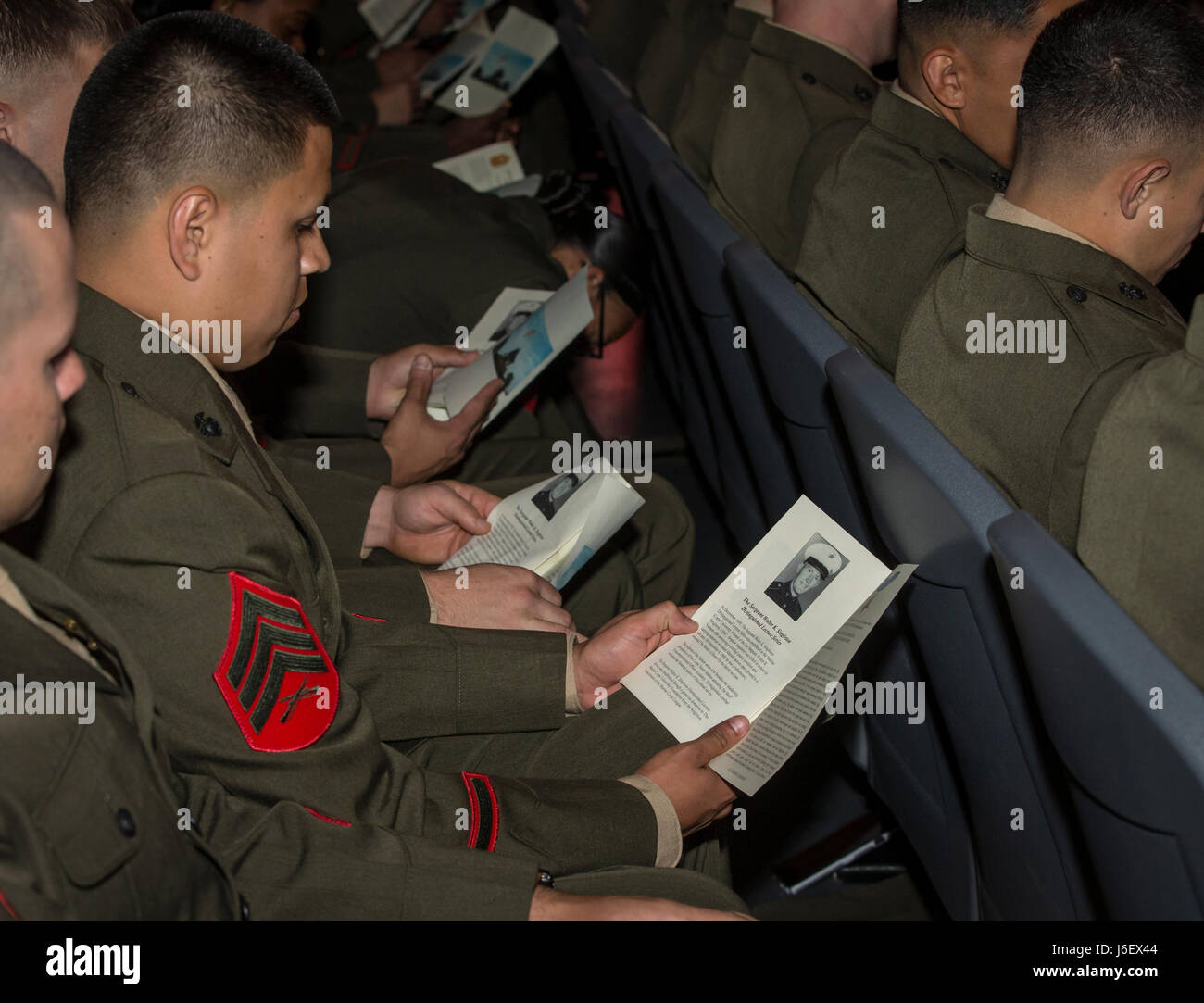 U.S. Marines look at their pamphlets during the 17th Sgt. Walter K. Singleton distinguished lecture series held at Warner Hall, Marine Corps Base Quantico, Va., May 8, 2017. Sgt. Singleton was killed in action in Vietnam and was posthumously awarded the Medal of Honor in 1968. The lecture series is held to broaden the leadership perspective of the Corps' future leaders attending the Staff Noncommissioned Officer Academy. (U.S. Marine Corps photo by: Lance Cpl. Micha R. Pierce) Stock Photo