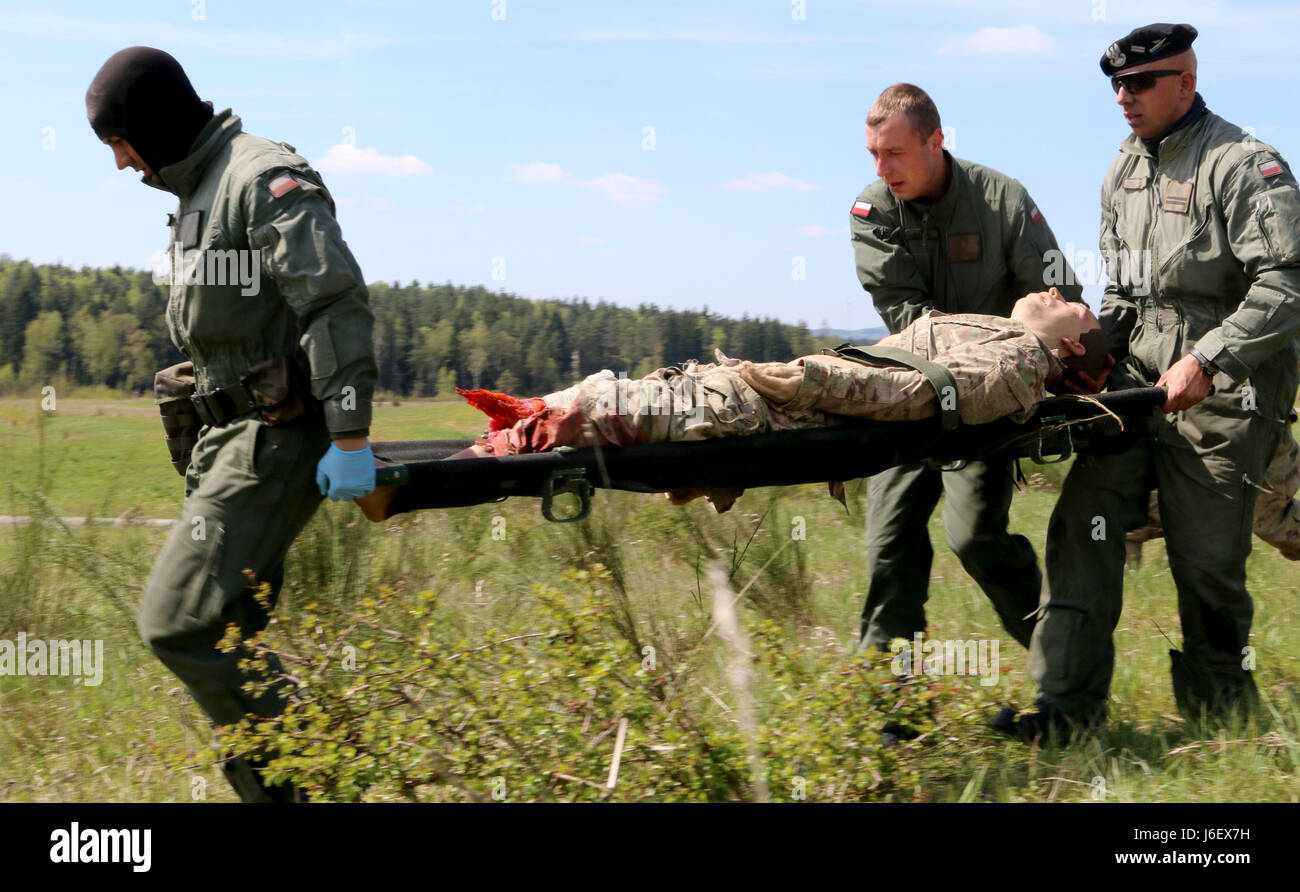Grafenwoehr, Germany (May 10, 2017) - Soldiers from the Polish Army evacuate a casualty during the Strong Europe Tank Challenge (SETC) medical evacuation lane, here. The SETC is co-hosted by U.S. Army Europe and the German Army, May 7-12, 2017. The competition is designed to project a dynamic presence, foster military partnership, promote interoperability, and competition.     #StrongEurope #TankChallenge #SETC Stock Photo