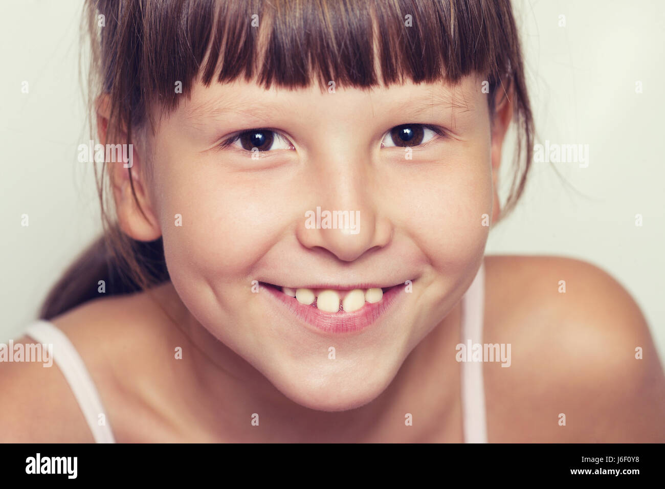 Happy Eight years girl wearing bangs closeup portrait Stock Photo Alamy