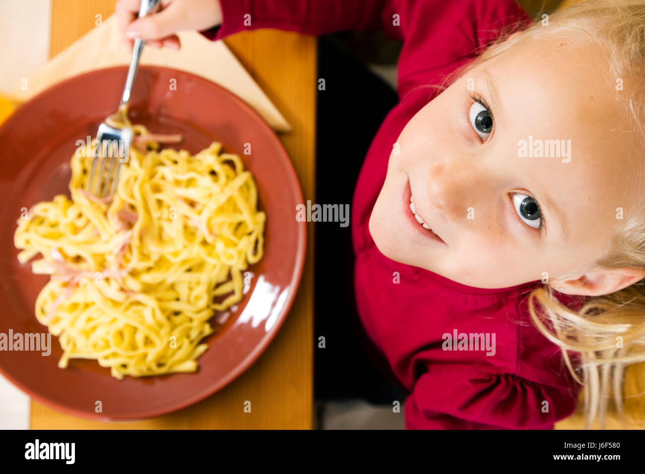 child with noodle dish Stock Photo Alamy
