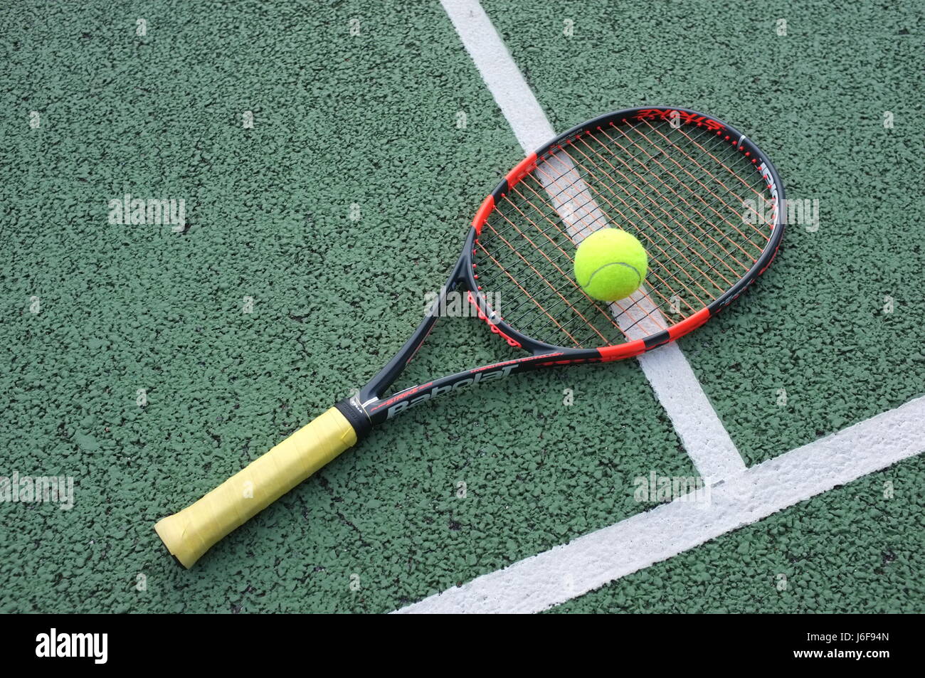 Tennis ball on a Babolat racquet on a hard court in London, UK Stock Photo