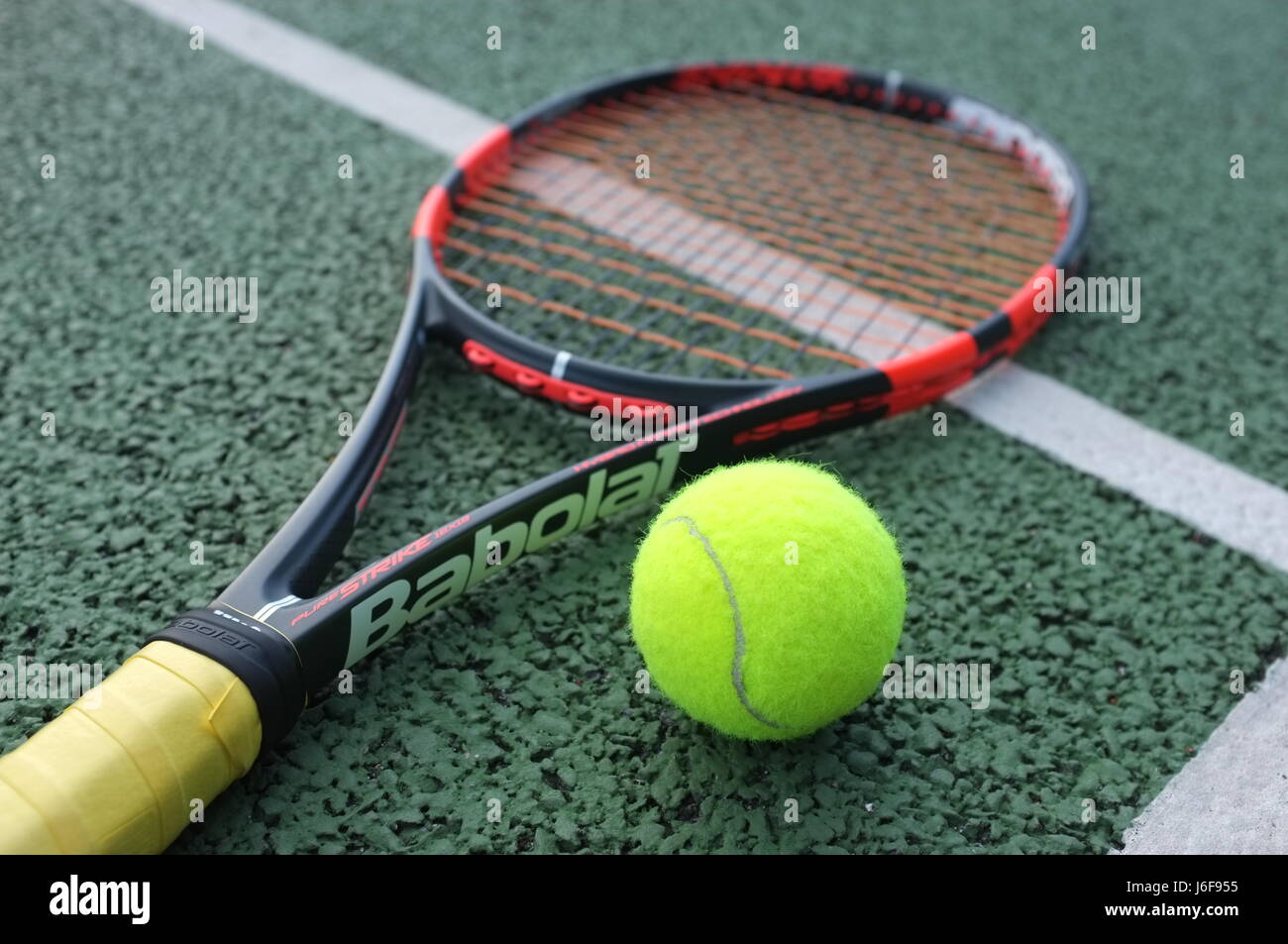 Tennis ball on a Babolat racquet on a hard court in London, UK Stock Photo