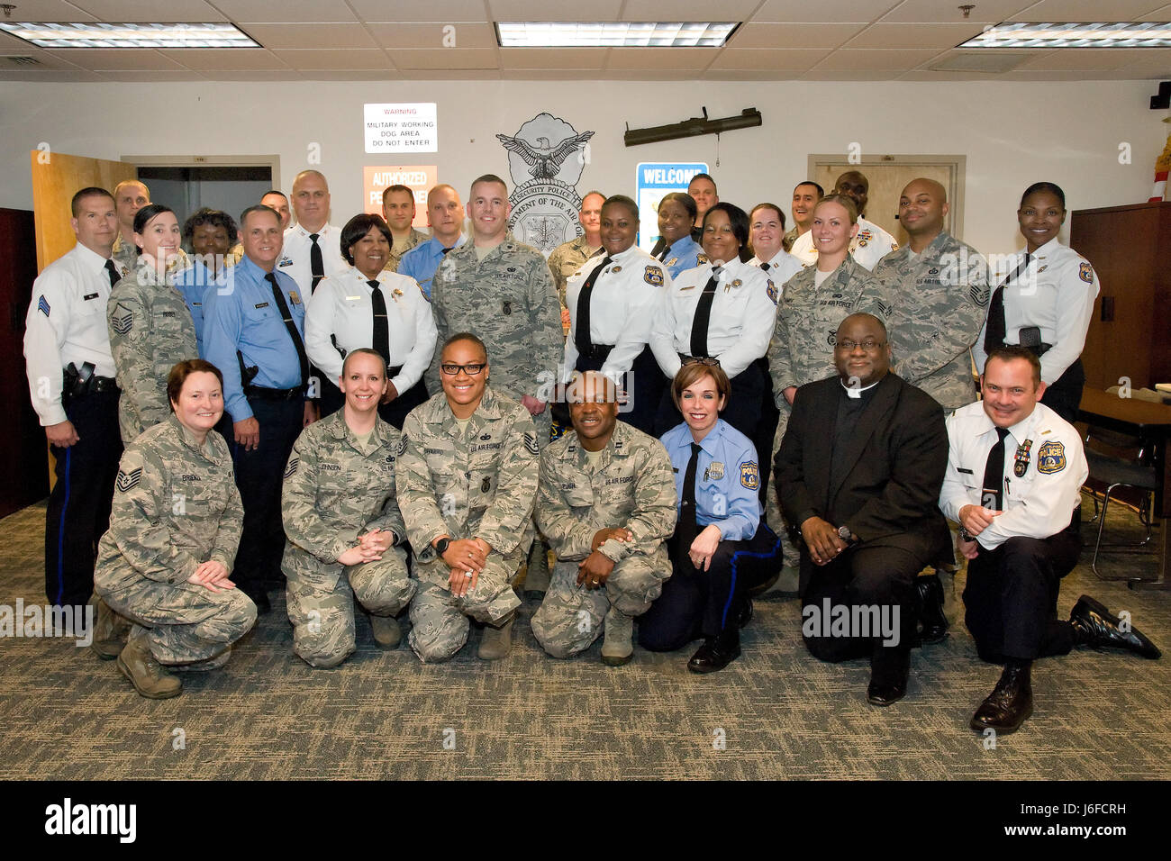 Members of the 436th Security Forces Squadron and Philadelphia Police Department, Philadelphia, Pa., pose for a group photo May 11, 2017, at building 910 on Dover Air Force Base, Del. Fifteen members of the police department received a mission brief, observed both a military working dog and a Raven Redman suit demonstration, a tour of Air Force Mortuary Affairs Operations and the Base Chapel. (U.S. Air Force photo by Roland Balik) Stock Photo