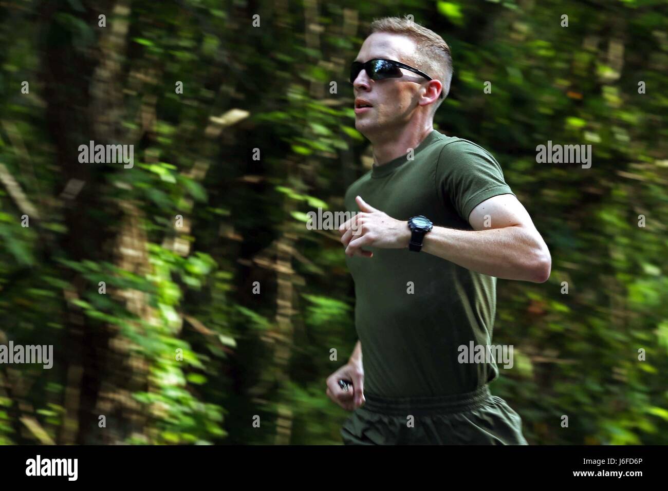 U.S. Marine Corps Lance Cpl. Austin Livingston, combat photographer, Headquarters and Support Battalion, Marine Corps Installations East, participates in a memorial run to honor fallen combat camera members, Camp Lejeune, N.C., May 11, 2017. Cpl. Sara Medina, a combat photographer, and Lance Cpl. Jacob Hug, a combat videographer, gave the ultimate sacrifice while providing humanitarian assistance and disaster relief to remote villages in Nepal in dire need of aid during Operation Sahayogi Haat. (U.S. Marine Corps photo by Lance Cpl. Kaitlynn M. Hendricks) Stock Photo