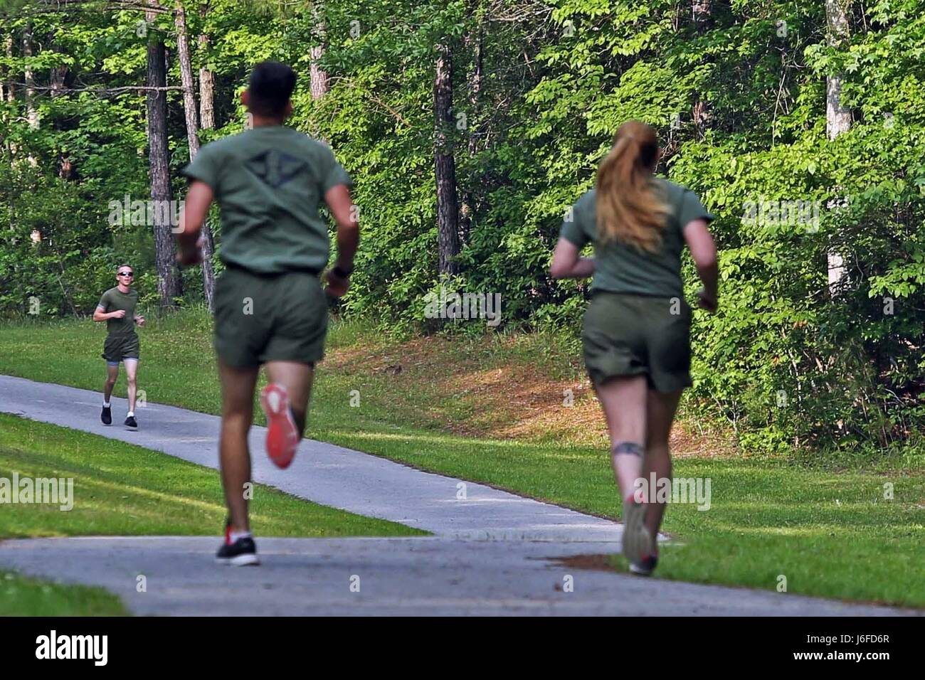 U.S. Marine Corps combat camera personnel from various units within the geographical area, participate in a memorial run to honor fallen combat camera members, Camp Lejeune, N.C., May 11, 2017. Cpl. Sara Medina, a combat photographer, and Lance Cpl. Jacob Hug, a combat videographer, gave the ultimate sacrifice while providing humanitarian assistance and disaster relief to remote villages in Nepal in dire need of aid during Operation Sahayogi Haat. (U.S. Marine Corps photo by Lance Cpl. Kaitlynn M. Hendricks) Stock Photo