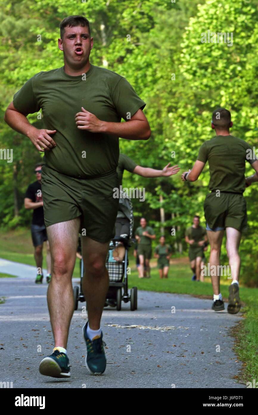 U.S. Marine Corps Sgt. Derek Picklesimer, reproduction specialist, Headquarters and Support Battalion, Marine Corps Installations East, participates in a memorial run to honor fallen combat camera members, Camp Lejeune, N.C., May 11, 2017. Cpl. Sara Medina, a combat photographer, and Lance Cpl. Jacob Hug, a combat videographer, gave the ultimate sacrifice while providing humanitarian assistance and disaster relief to remote villages in Nepal in dire need of aid during Operation Sahayogi Haat. (U.S. Marine Corps photo by Lance Cpl. Kaitlynn M. Hendricks, MCIEAST Combat Camera/Released) Stock Photo