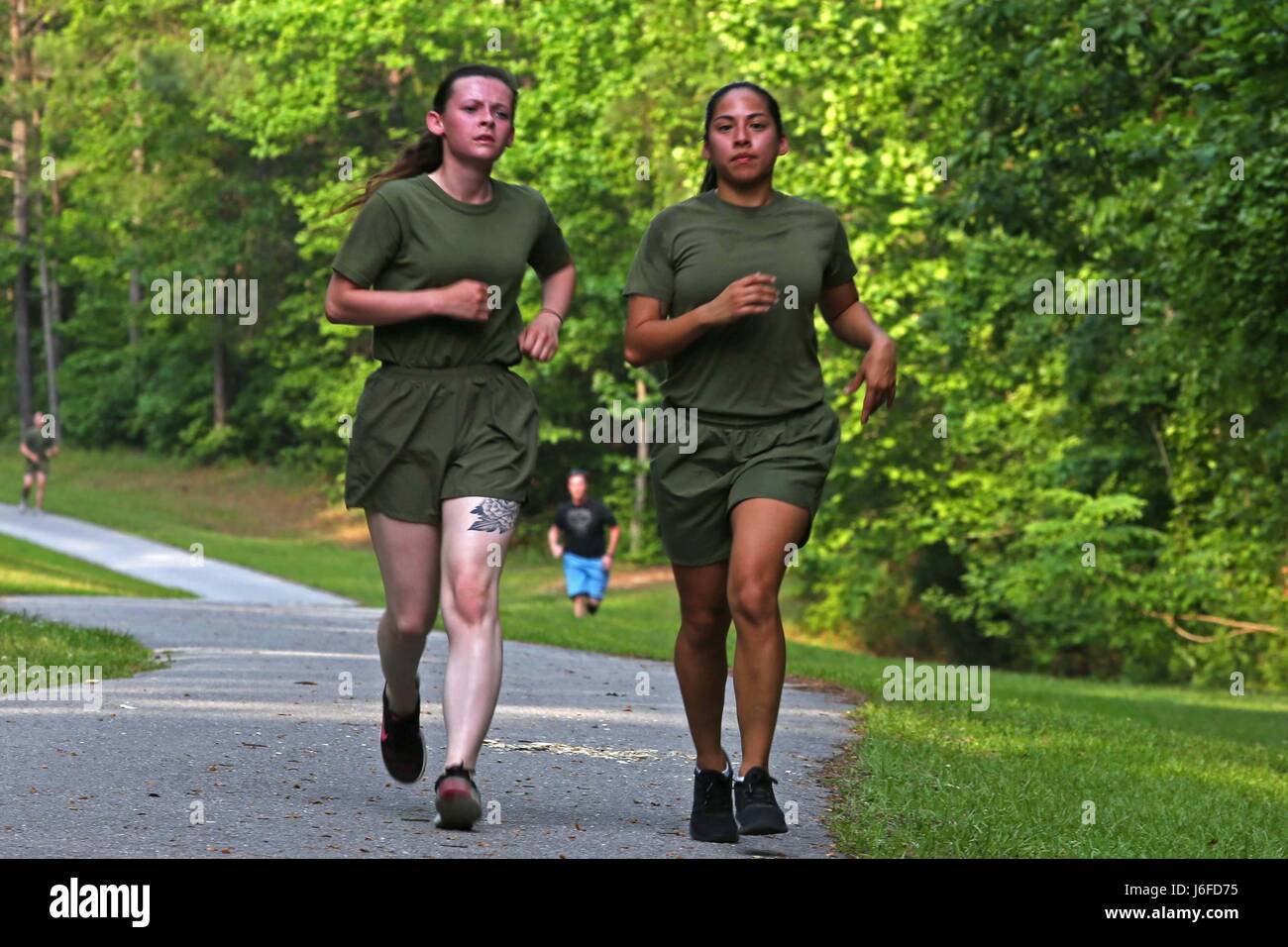 U.S. Marine Corps combat camera personnel from various units within the geographical area, participate in a memorial run to honor fallen combat camera members, Camp Lejeune, N.C., May 11, 2017. Cpl. Sara Medina, a combat photographer, and Lance Cpl. Jacob Hug, a combat videographer, gave the ultimate sacrifice while providing humanitarian assistance and disaster relief to remote villages in Nepal in dire need of aid during Operation Sahayogi Haat. (U.S. Marine Corps photo by Lance Cpl. Kaitlynn M. Hendricks, MCIEAST Combat Camera/Released) Stock Photo