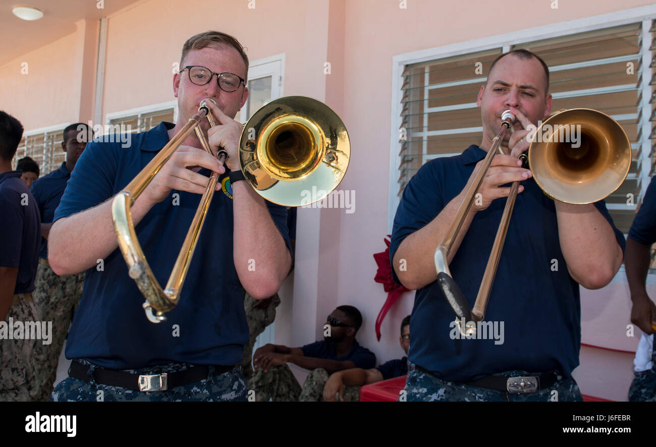 170512-N-OU129-015 DA NANG, Vietnam (May 12, 2017) Musician 2nd Class Chris Lang (left) and Musician 2nd Class James Brownell (right) of the U.S. 7th Fleet Band, Far East Edition, play trombones at the ribbon cutting ceremony for the Hoa Lien Nursery School during Pacific Partnership 2017 Da Nang May 12. Pacific Partnership is the largest annual multilateral humanitarian assistance and disaster relief preparedness mission conducted in the Indo-Asia-Pacific and aims to enhance regional coordination in areas such as medical readiness and preparedness for manmade and natural disasters. (U.S. Navy Stock Photo