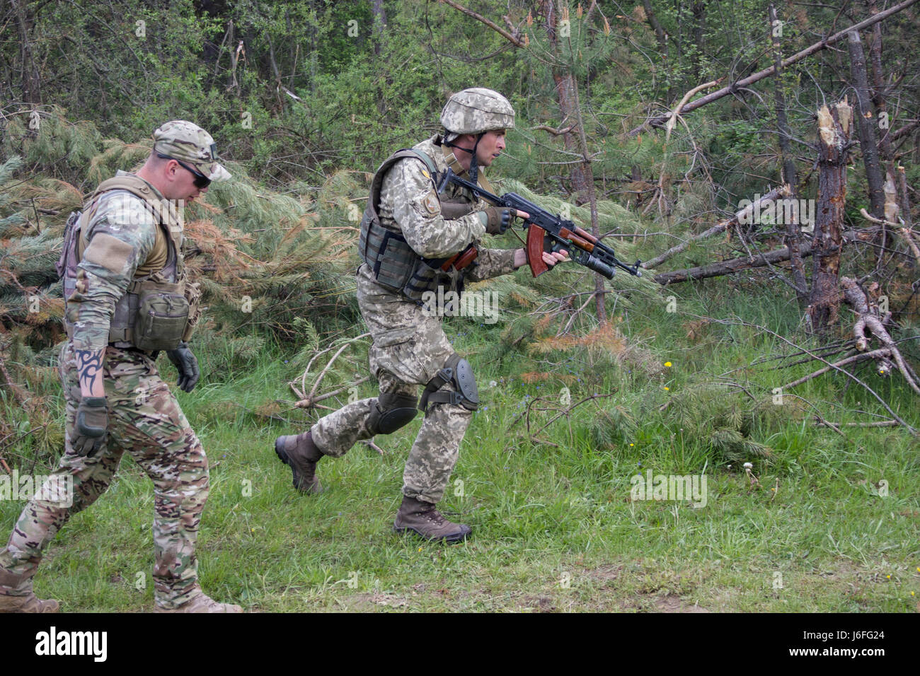 A Yavoriv Combat Training Center trainer observes and coaches a ...