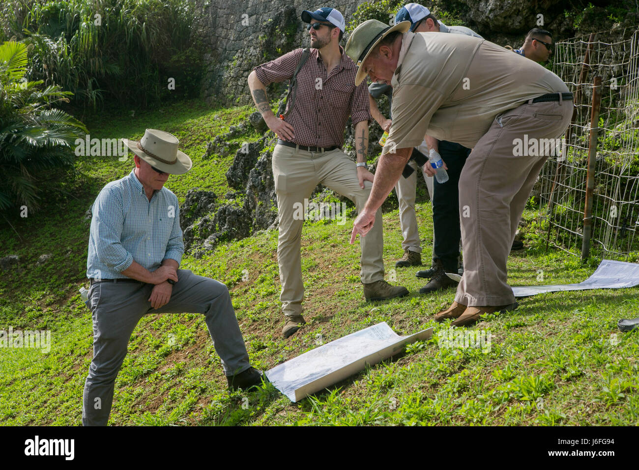 U.S. Marine Corps Lt. Gen. Lawrence D. Nicholson, III Marine Expeditionary Force (MEF) commanding general, left, and David Leipold, a civilian contractor with the Information Management Office at III MEF, right, study a map during a Battle of Okinawa Tour on Okinawa, Japan, May 15, 2017. The battle tour was conducted to build a greater understanding of Marine Corps history on Okinawa through facilitated discussion and a guided tour, while building camaraderie and espirit de corps among the III MEF staff. (U.S. Marine Corps photo by MCIPAC Combat Camera Lance Cpl. Sean M. Evans) Stock Photo