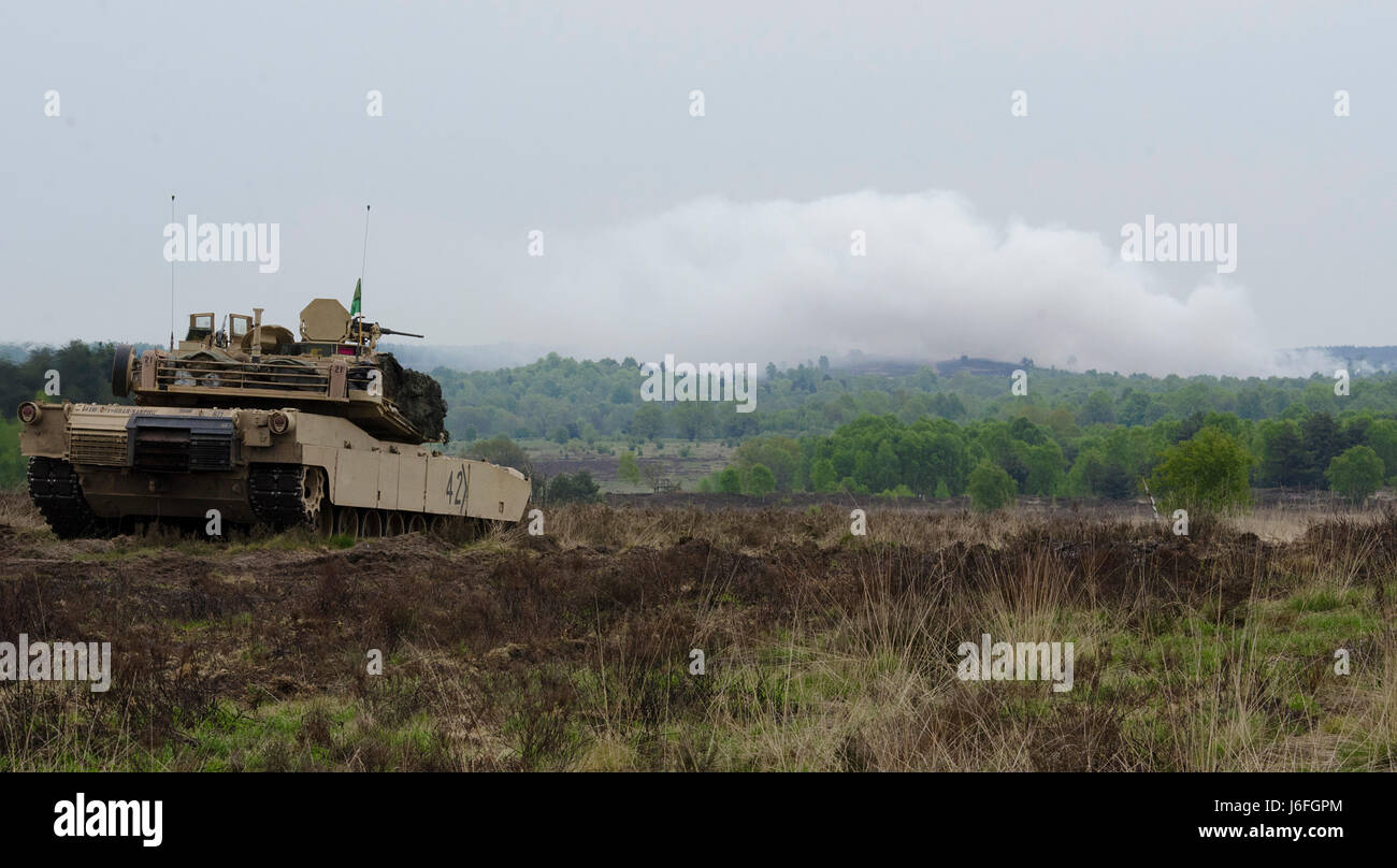 A U.S. M1A2 Abrams main battle tank scans its sector for targets during the German led exercise Haffschild, at training area Bergen-Hohne, May 16, 2017. Maintaining combat readiness is a top priority for the 3rd ABCT. Training alongside NATO Allies and partners, as part of Operation Atlantic Resolve, provides unique opportunities to sharpen skills and sustain the ability to shoot, move and communicate as a combined arms team. (U.S. Army photo by Sgt. Justin Geiger) Stock Photo