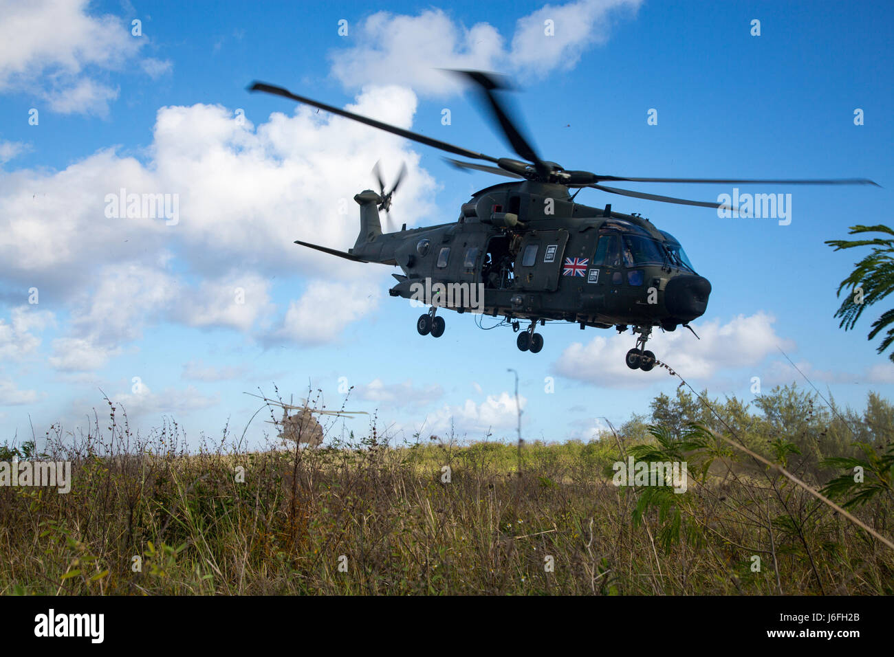 A paid of British MK3 Merlin helicopters lift off after inserting U.S. Marines on the Island of Tinian, in the Commonwealth of the Northern Mariana Islands, May 16, 2017. Marines and Sailors are participating in a two week integrated exercise, Jeanne D’ Arc. The French-led exercise which strengthens strategic partnerships and exercising freedom of navigation operations across the Indo-Asia-Pacific region. . (U.S. Marine Corps photo by MCIPAC Combat Camera Lance Cpl. Caleb T. Maher) Stock Photo