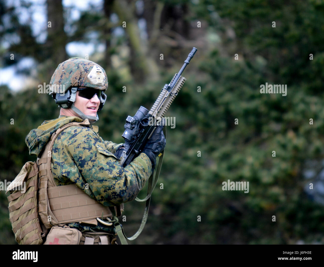U.S. Marine Corps Sgt. Joshua Godfrey, foreign weapons instructor, Combat Marksmanship Company, Weapons Training Battalion, awaits further instruction for a ...