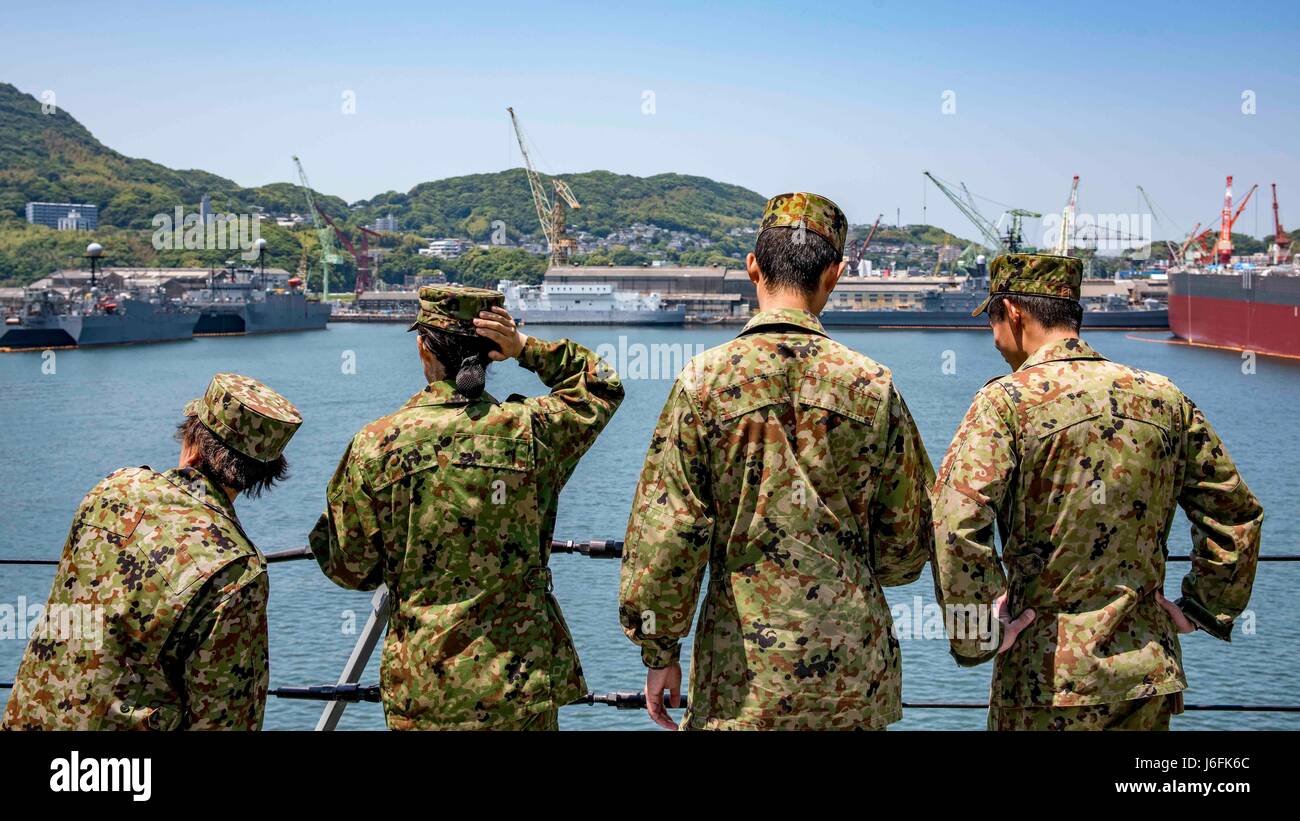 170518-N-JH293-048 SASEBO, Japan (May 18, 2017) Japan Ground Self-Defense Force (JGSDF) personnel take a tour of the amphibious transport dock USS Green Bay (LPD 20). The JGSDF group toured Green Bay as part of a Basic Enlisted English class meant to enhance language proficiency and cultural understanding between the U.S. and Japanese forces. (U.S. Navy photo by Mass Communication Specialist 1st Class Chris Williamson/Released) Stock Photo