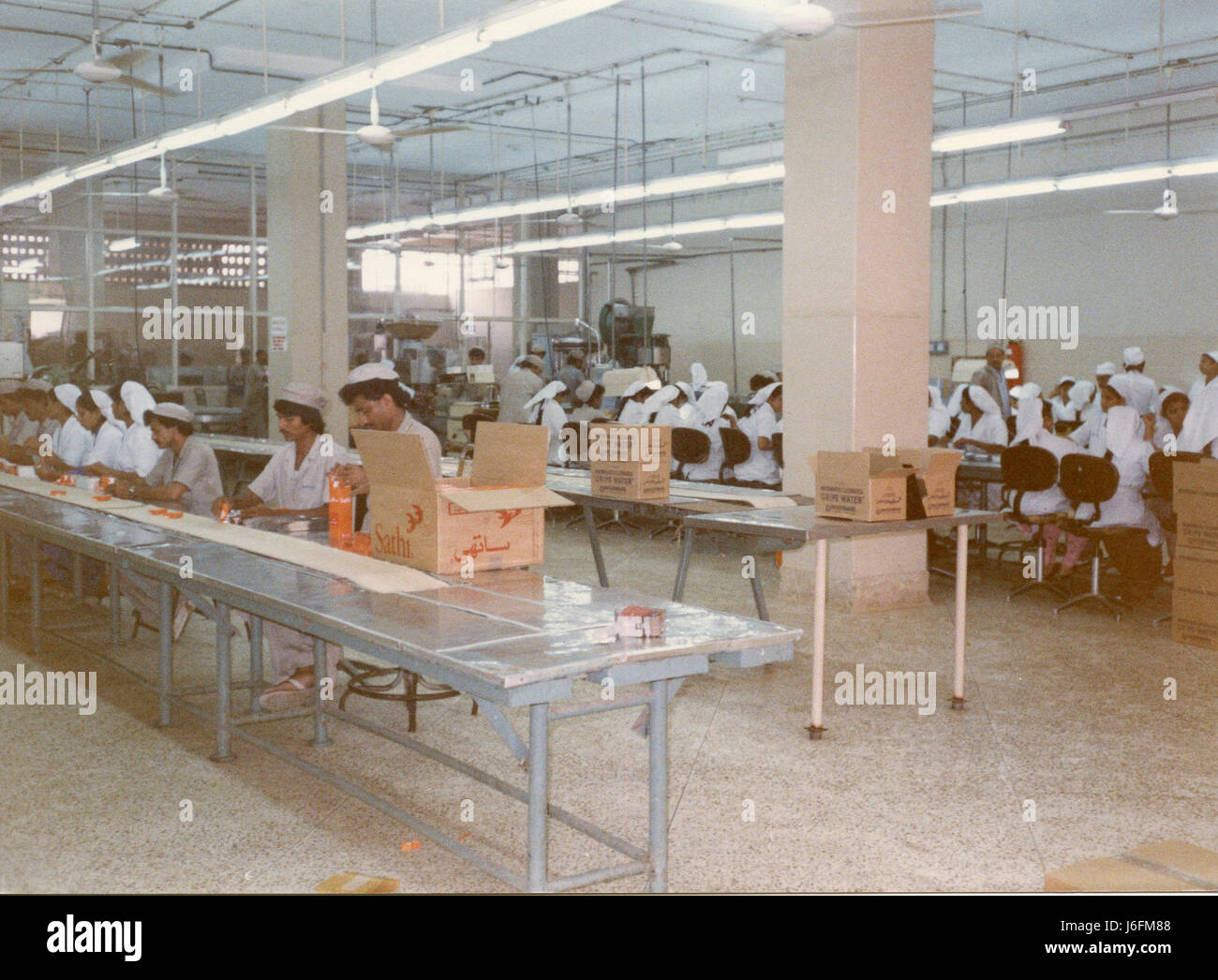 Military personnel work on an assembly or production line at a facility ...