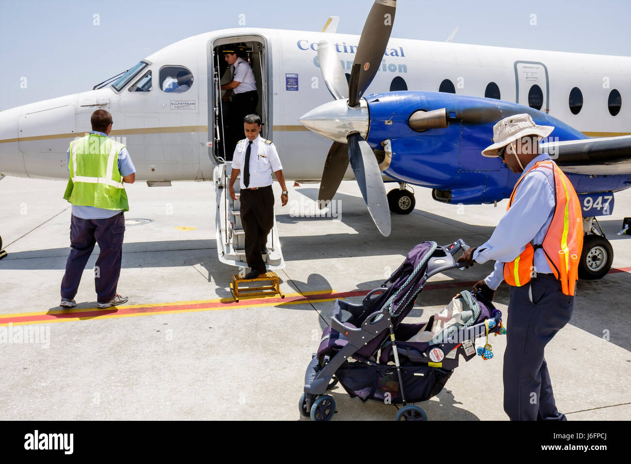 Tampa Florida,Tampa Airport,Continental Airlines,Connection,commuter flight,aircraft,tarmac,man men male,co pilot,ground crew,stroller,stowed steps,do Stock Photo
