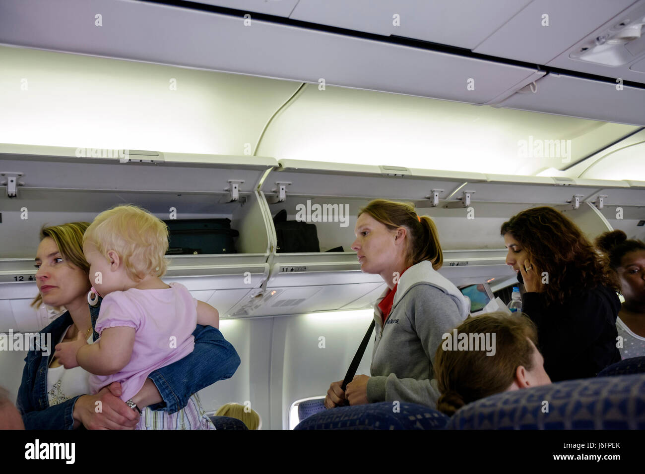 Atlanta Georgia,Hartsfield Jackson Atlanta International Airport,Delta Airlines,woman carries baby babies,women,girl girls,youngster youngsters youth Stock Photo