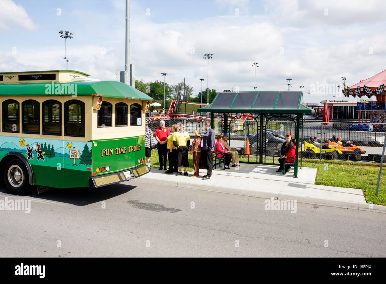 Sevierville Tennessee,Smoky Mountains,NASCAR Speedpark Trolley Stop,men,women,group,seniors,tourists,Fun Time,trolley stop,bus shelter,boarding,attrac Stock Photo