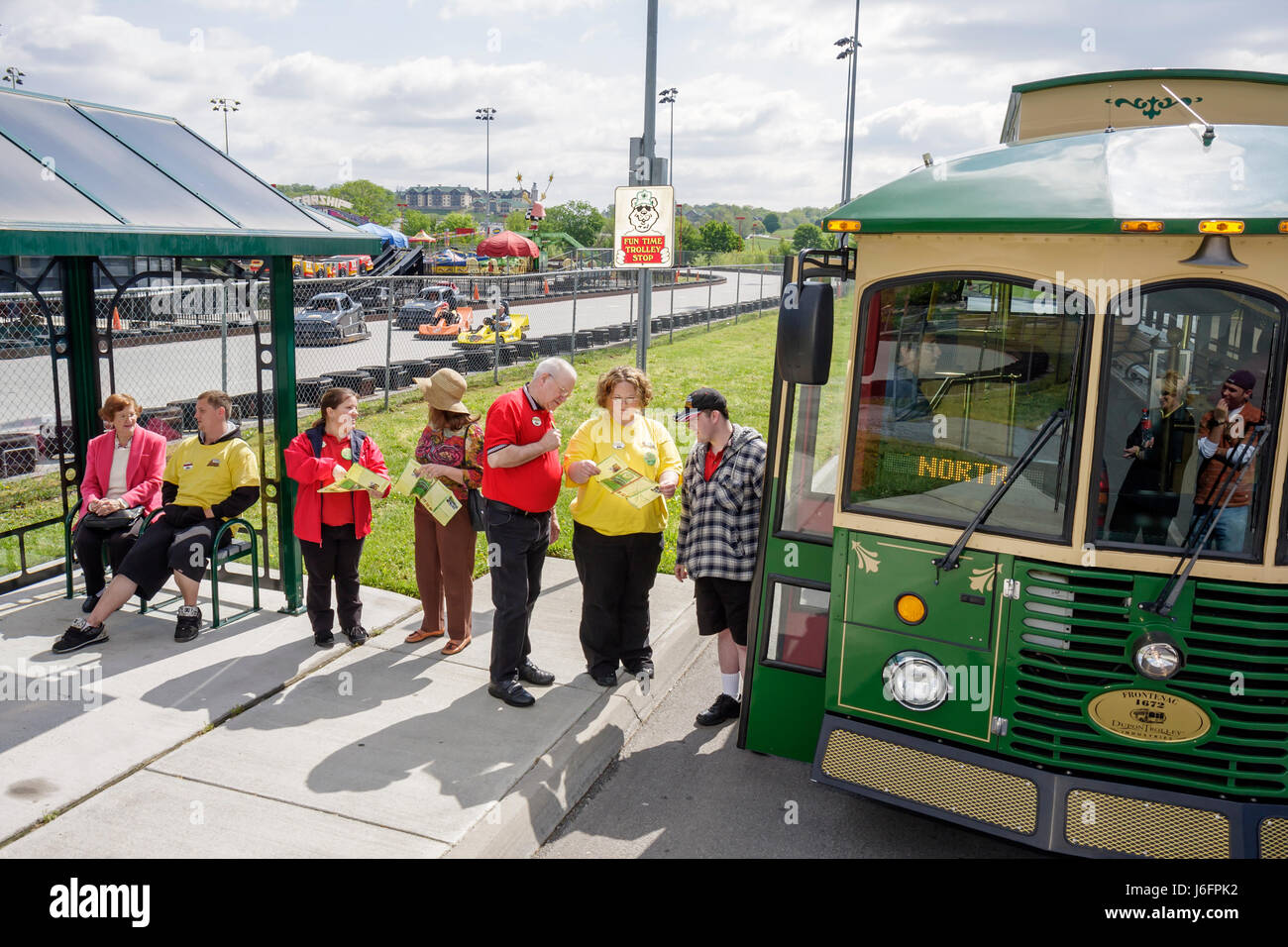 Sevierville Tennessee,Smoky Mountains,NASCAR Speedpark Trolley Stop,men,women,group,seniors,Fun Time,trolley stop,bus shelter,boarding,attraction,map, Stock Photo