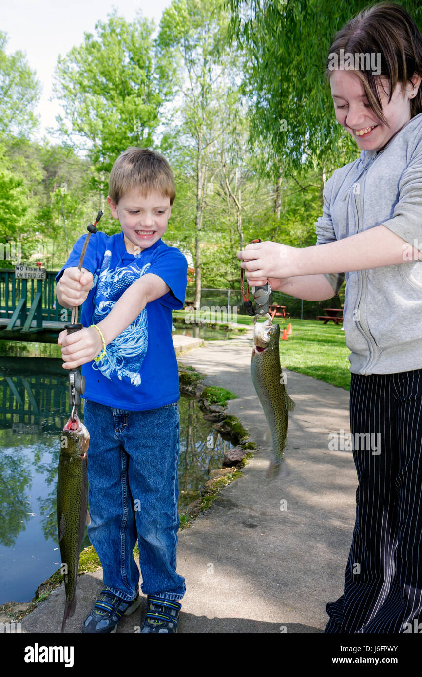 Sevierville Tennessee,Smoky Mountains,English Mountain Trout Farm & Grill,catch,eat,rainbow trout,boy boys,male kid kids child children youngster,girl Stock Photo