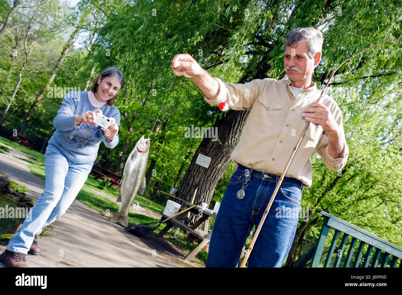 Sevierville Tennessee,Smoky Mountains,English Mountain Trout Farm & Grill,catch,eat,rainbow trout,man men male,woman female women,couple,catch,camera, Stock Photo