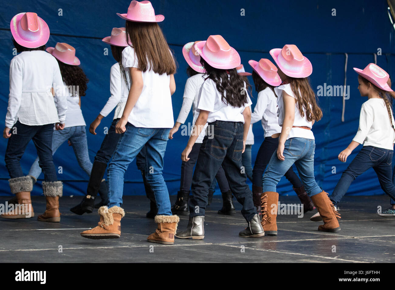 Slough, UK. 20th May, 2017. Western House Academy perform line dances at  the Diverse Steps: Dance in Unity showcase in Slough town square to  celebrate World Diversity Day. The event was organised