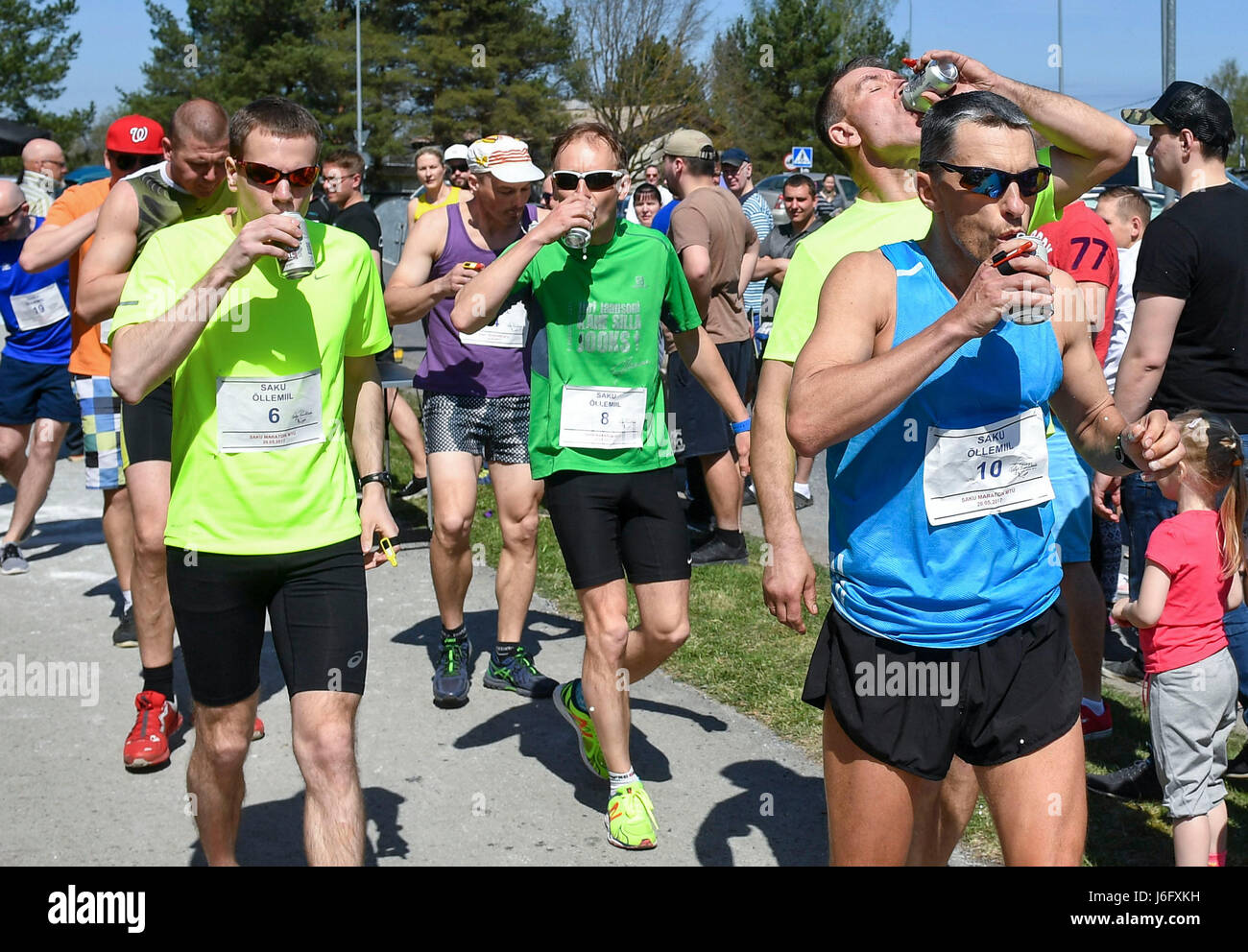 Saku, Estonia. 20th May, 2017. Participants drink beer during the Beer Mile Run in Saku, Estonia, May 20, 2017. Participants must run four laps for a total of one mile distance and start each lap by drinking a can of beer. Credit: Sergei Stepanov/Xinhua/Alamy Live News Stock Photo