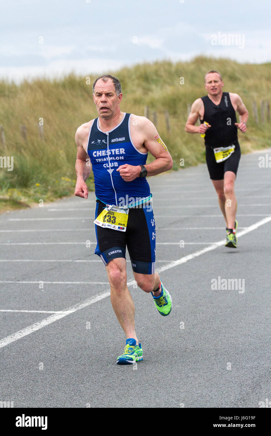 Two male runners competing in a triathlon in Southport, Merseyside, UK