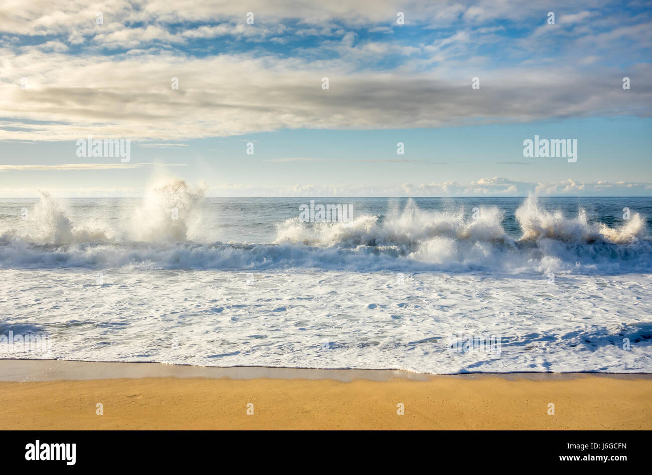 Large waves breaking on the shore at Sunset Beach on the North Shore of Oahu, Hawaii. Stock Photo