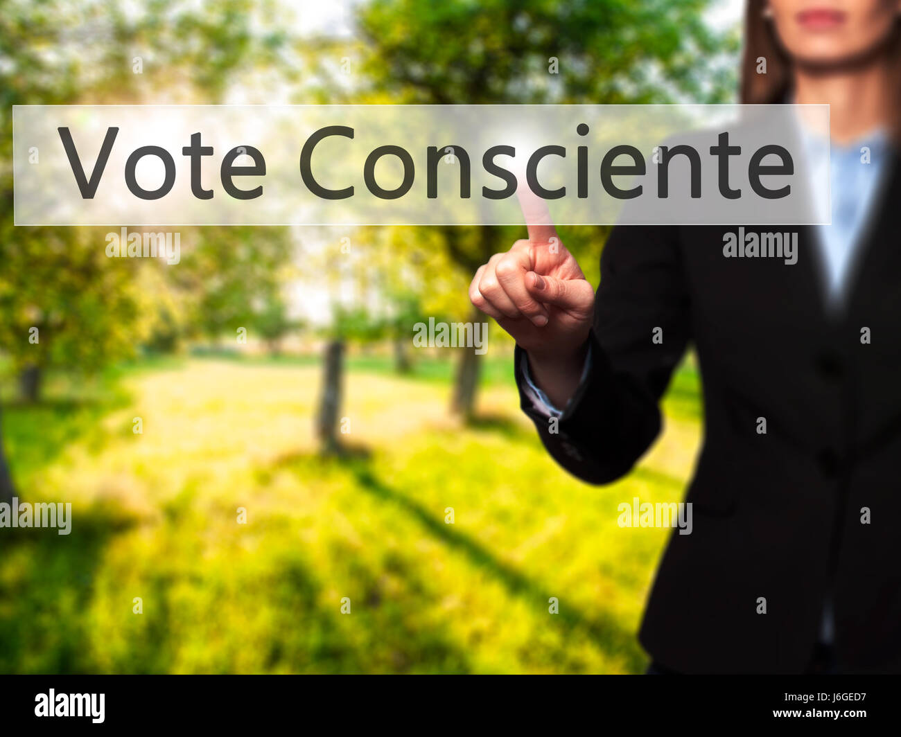 Vote Consciente - Businesswoman hand pressing button on touch screen interface. Business, technology, internet concept. Stock Photo Stock Photo