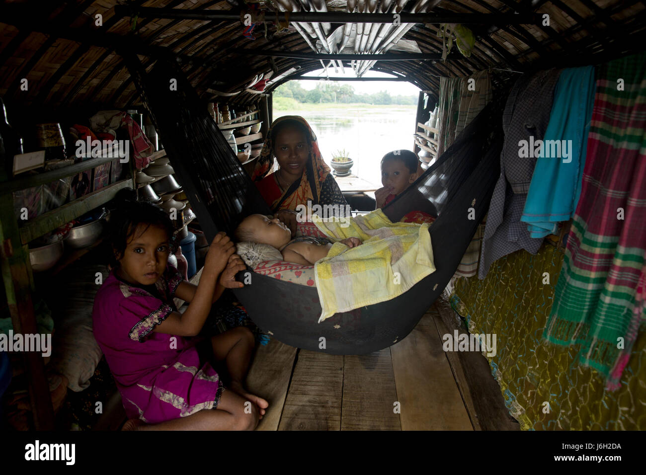 A gypsy family on a floating boat at Pubail in Gazipur, Bangladesh. Stock Photo
