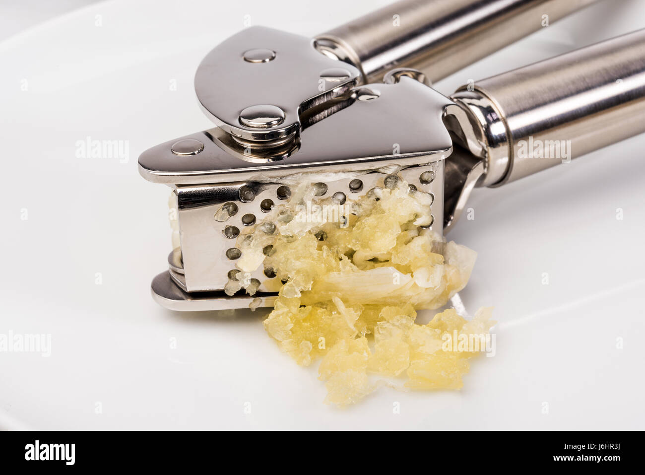squeeze garlic Fresh French garlic and press Stock Photo Alamy