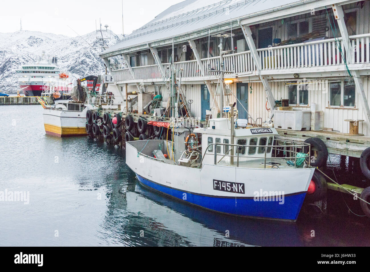 Fishing boats and the Hurtigruten Coastal Express cruise ship MS Nordnorge are berthed at Honningsvåg, Finnmark County, Norway. Stock Photo