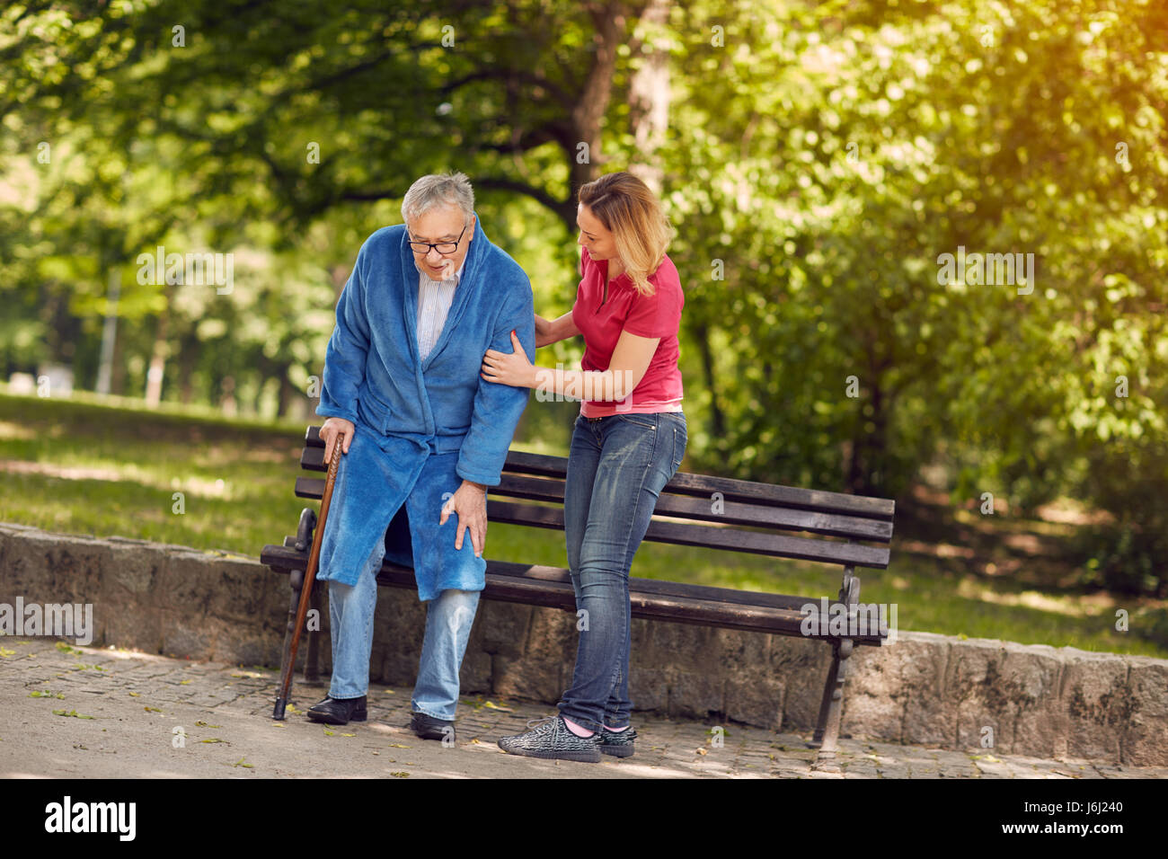 Smiling Daughter Helping Senior Disabled Father In Park Stock Photo - Alamy