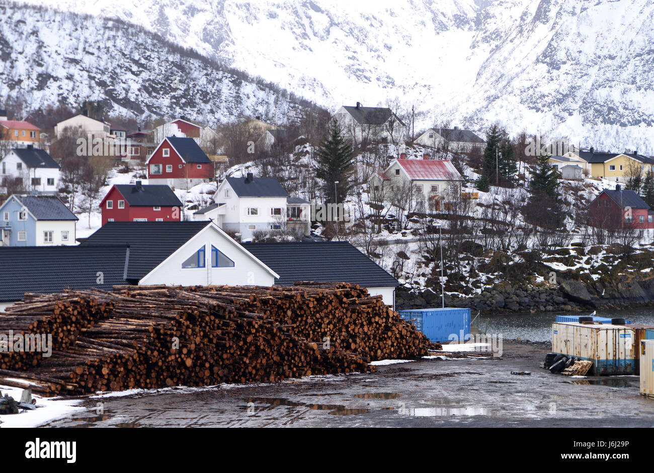 Timber stacked on the quay at Stokmarknes.  Stokmarknes, Nordland, Norway. Stock Photo