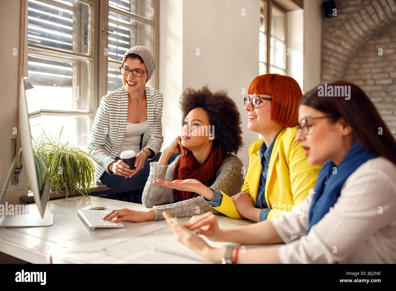 Group of creative female fashion designers on workplace in office Stock ...