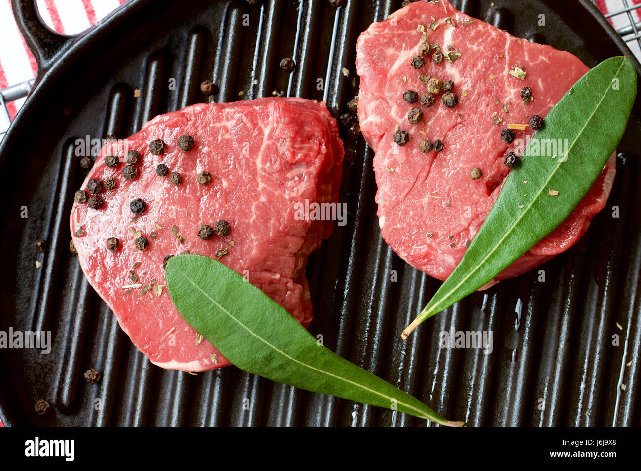 Raw beef eye fillet steak and peppercorns Stock Photo Alamy